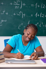 Black female student in front of chalkboard  