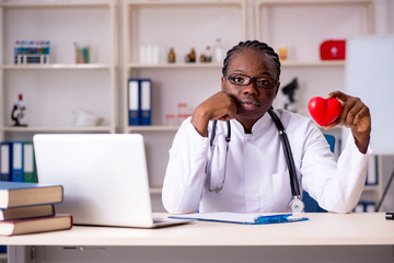 Fototapeta premium Black female doctor working at clinic 