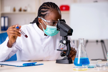 Young black chemist working in the lab 