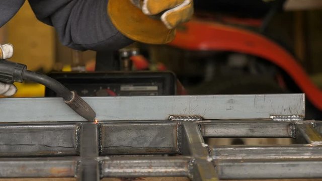 Close up of a mig welder welding steel