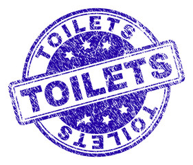TOILETS stamp seal imprint with distress texture. Designed with rounded rectangles and circles. Blue vector rubber print of TOILETS tag with unclean texture.