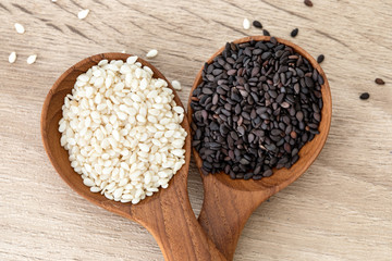 organic Black and White sesame seeds in a wooden spoon ,healthy food for reductions in both systolic and diastolic blood pressure