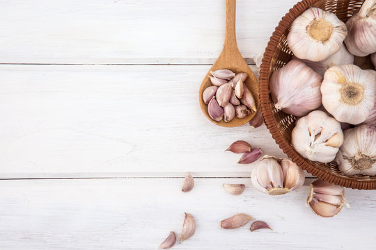 Close Up Group Of A Garlic On White Wooden Table Board , Top View Or Overhead Shot With Copy Space