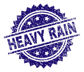 HEAVY RAIN stamp seal watermark with distress style. Blue vector rubber print of HEAVY RAIN tag with corroded texture.