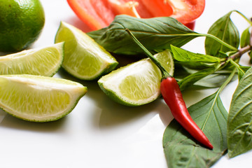 Fresh Green Limes with Hot Thai Chili Pepper and Red Pepper