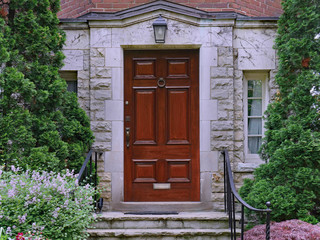 elegant dark wood door of stone fronted house