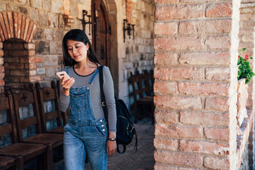 visitor walking in long stone red brick corridor