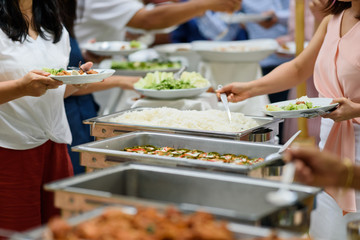 scooping the food, buffet food at restaurant, catering 