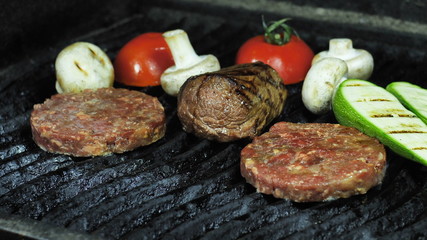 Close-up of two cutlets piece of meat and grilled vegetables