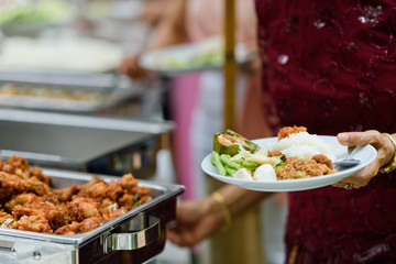 scooping the food, buffet food at restaurant, catering 