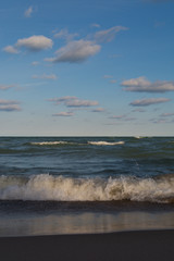 Lake Michigan on a beautiful Autumn morning with blue skies and clouds above.  Indiana Dunes, Indiana, USA