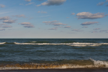 Lake Michigan on a beautiful Autumn morning with blue skies and clouds above.  Indiana Dunes, Indiana, USA