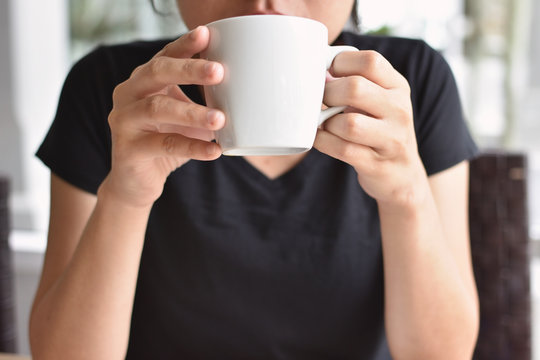 Woman drinking coffee in the morning at home