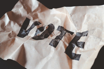 crumpled brown paper with word vote printed, collapse of democracy concept