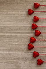 Red hearts on wooden table. Blank greeting card background for Valentine's Day. Place for text, copy space.