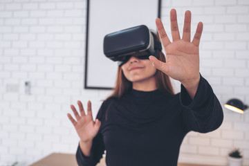 An asian woman wearing VR camera while enjoy playing games