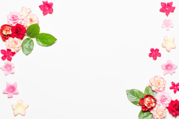 Frame made of rose flowers on white background. Top view with copy space.