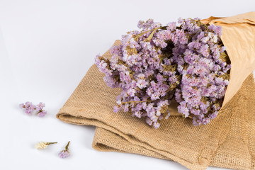 Bouquet of purple dried flowers on sackcloth