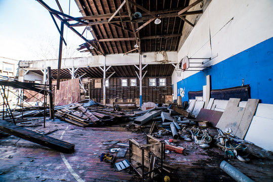 Abandoned gymnasium, kids football pads, score board numbers