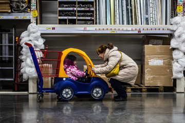 mother walks with the child to the store