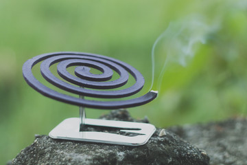 Insect repellent mosquito coil incense smoking.