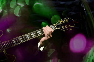 Fototapeta na wymiar musician's hand on the neck of the guitar