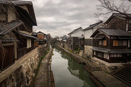 Historic wooden buildings line canal in old Japanese merchant village