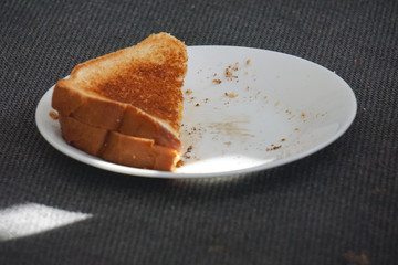 Boy eating grilled cheese sandwich.