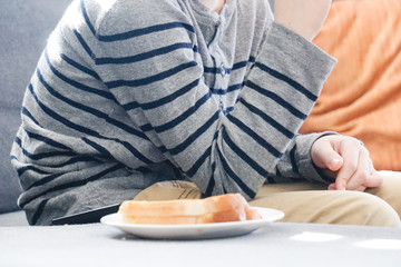 Boy eating grilled cheese sandwich.