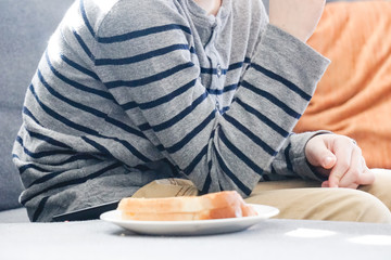 Obraz na płótnie Canvas Boy eating grilled cheese sandwich.