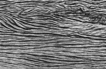 Wood grain texture with dark grooves forming an abstract pattern