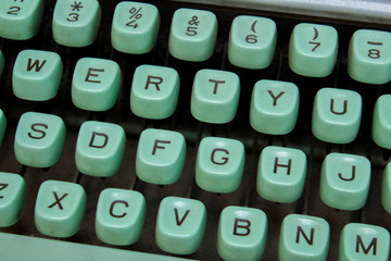 turquoise blue keys of a vintage typewriter close-up with the English alphabet