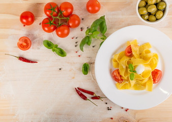 Yellow italian pasta pappardelle, fettuccine or tagliatelle