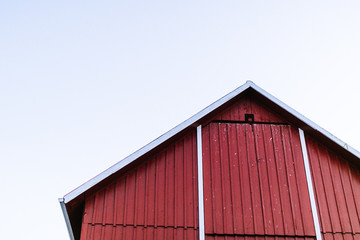 red barn on cloudy day looking up