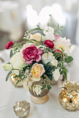bouquet of wedding flowers in vase sitting on table