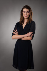 Beauty portrait of a cute young woman over gray background