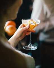 woman holding a martini drink at a party