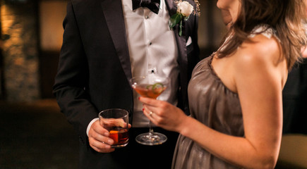 man and woman holding a beverage glass at a wedding party