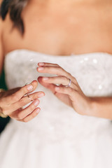 bride putting on wedding ring