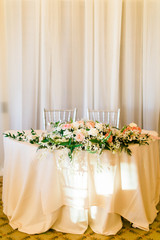 bride and groom's wedding table set with flowers for dinner