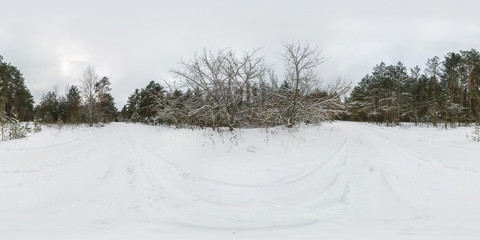Winter full spherical 360 degrees angle view panorama road in a snowy pinery forest with gray pale sky in equirectangular projection. VR AR content