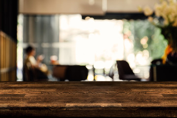 Empty wood table with Blurred background made with Vintage Tones, Coffee shop blur background with bokeh lights.