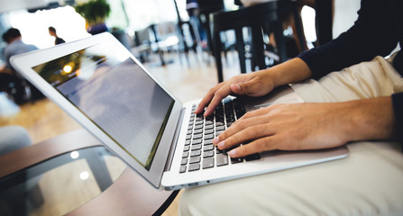 Business man working at a coffee shop with a laptop.