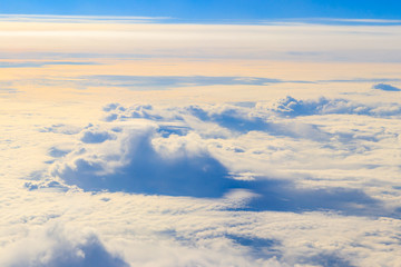 Beautiful white clouds in blue sky. View from airplane
