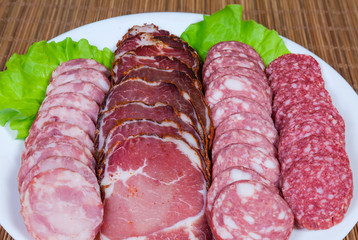 Cold cut of dried meat and different sausages close-up