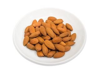 Almonds peeled from shells  on a white saucer