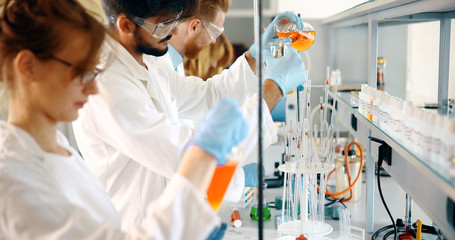 Young students of chemistry working in laboratory