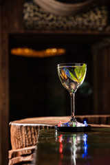 Transparent Alcoholic cocktail with mint on the bar counter