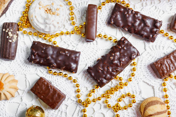 Set of delicious cookies, chocolates, biscuits on  table