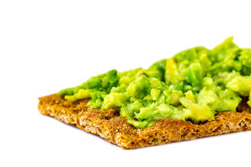 Crisp rye bread with avocado cream isolated. Avocado sandwich on a white background